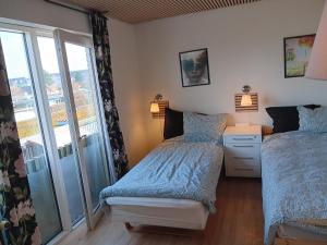a bedroom with two beds and a balcony at Private room near Copenhagen in Ishøj