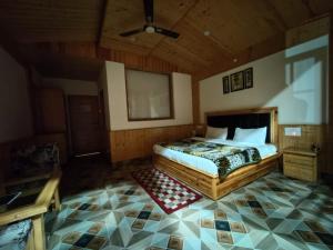 a bedroom with a bed and a ceiling at Hotel Saryal , Kullu in Kulu