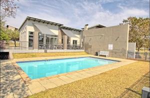 a swimming pool in front of a house at Gwendol’s place @ThePaddocks in Sandton