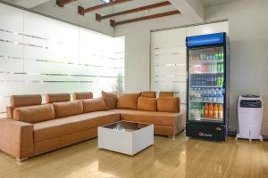 a living room with a couch and a drink cooler at FabHotel Emersion Residency in Pune
