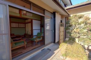 a house with a sliding glass door with a patio at 貸切御宿　憩（Ikoi）/ Nikko Kinugawa Area in Imaichi