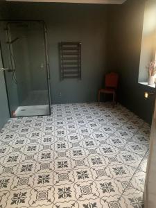 a bathroom with a shower and a tiled floor at House of silence 