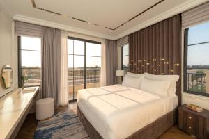 a bedroom with a large bed and large windows at The Residence Resort & Villas Phu Quoc in Phu Quoc +79 photos