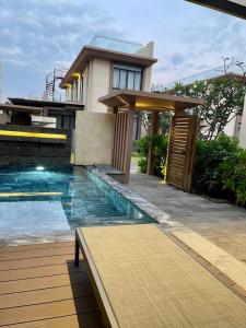 a house with a swimming pool in front of a house at Big Star Villas - Wyndham Garden in Cam Ranh