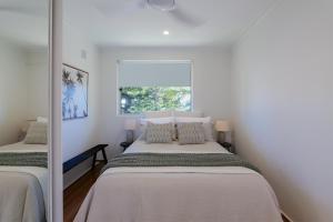 a bedroom with two beds and a window at Manly Beach Haven w Parking in Sydney