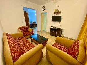 a living room with two couches and a tv at Apricot BH6 in Marmagao