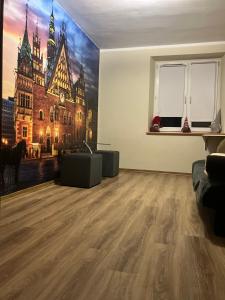 a living room with a large painting on the wall at Apartament Księże Małe in Wrocław