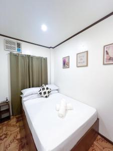 Postel nebo postele na pokoji v ubytování Corazon El Nido Inn