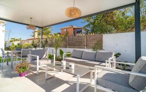 a patio with couches and chairs and a table at Gorgeous Home In Chiclana De La Fronter in Chiclana de la Frontera
