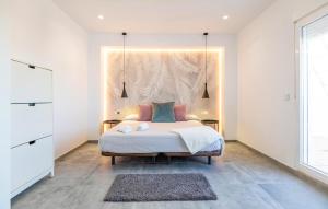 a bedroom with a bed with a large headboard at Gorgeous Home In Chiclana De La Fronter in Chiclana de la Frontera