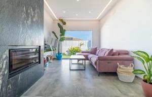 a living room with a couch and a fireplace at 3 Bedroom Awesome Home In Chiclana De La Fronter in Chiclana de la Frontera