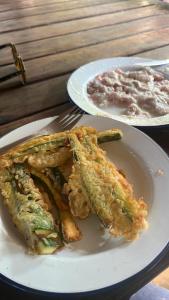 two plates of food on a table with a plate of food at Sazani Beach Lodge and Tidal Lounge in Nungwi