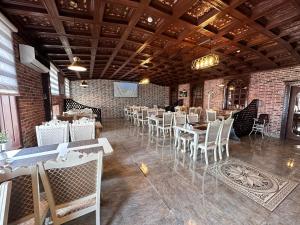 a dining room with tables and chairs in a building at Starway Hotel in Lankaran