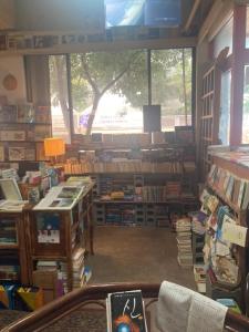 a library filled with lots of books and a large window at Book Hotel in Jeju