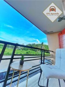 a balcony with a table and chairs and a view at GTC Apartelle in Tacloban