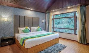 Postel nebo postele na pokoji v ubytování Treebo Eeshan Rodhi Resort, Darjeeling + 28 fotografií
