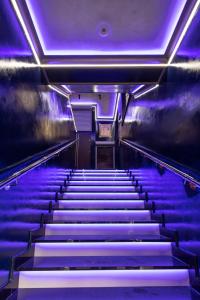 an empty escalator with purple lights on it at Tawerna Sandomierz in Sandomierz