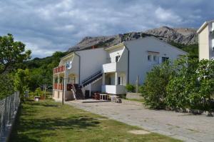un edificio con una montagna sullo sfondo di Apartments Aneva 1 a Baška
