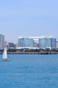 a sailboat in the water with a city in the background at Wyndham Grand Plaza Royale Yuzhou Xiamen - Wuyuan Bay in Xiamen