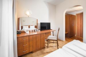 a bedroom with a desk with a television and a mirror at Room in BB - Hotel Moura Double Room n5166 in Borovets