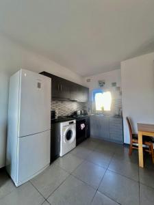 a kitchen with a white refrigerator and a dishwasher at 83/3-Lovely 1 Bedroom Penthouse in Birkirkara