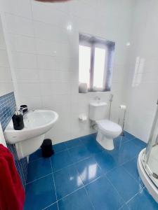 a white bathroom with a toilet and a sink at 83/3-Lovely 1 Bedroom Penthouse in Birkirkara