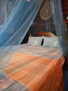a bedroom with a bed with a mosquito net at Bird House Mirissa in Mirissa
