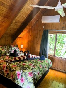 a bedroom with two beds in a room with wooden walls at Muri Vista Villas in Muri