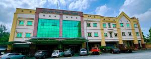 a large building with cars parked in front of it at GRAND FAR EAST HOTEL SDN BHD in Masai