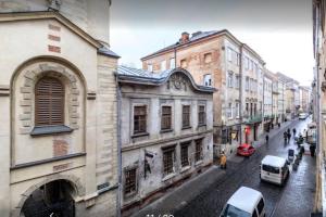 uitzicht op een straat met gebouwen en auto's bij Вірменська 12 in Lviv