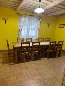 a dining room with a wooden table and chairs at Penzion Relax in Nižná