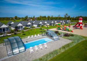 an aerial view of a park with a pool and a playground at Domki Letniskowe Biała Perła in Jezierzany