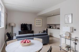 a living room with a couch and a table at Parkside House - Regent's Park - by Frankie Says in London