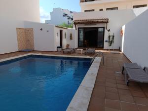 a swimming pool in the backyard of a house at Hostal Horizonte in San Antonio