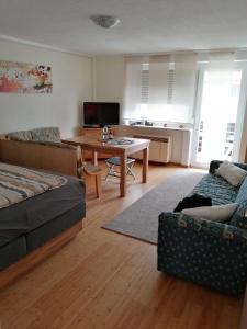 a living room with a couch and a table at Ferienwohnung Gruberhörndlblick in Inzell