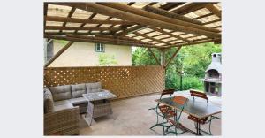 a patio with a couch and a table and chairs at Workers Apartment für die besten Monteure in Leoben und Bruck an der Mur in Oberaich