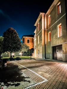 un edificio por la noche con una calle adoquinada en Naboo Verona Luxury Suites en Verona