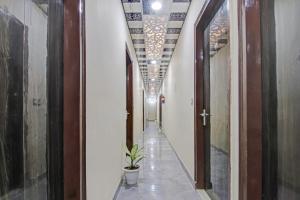 un corridoio con una pianta al centro di un edificio di OYO Flagship 87416 Hotel Moonstar a Ghaziabad