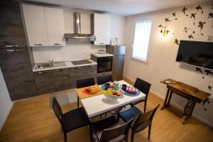 a kitchen with a table with a bowl of food on it at L'Alba dei Pescherecci VISTA CANALE in Chioggia
