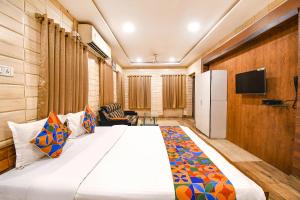 a hotel room with a bed and a tv at FabExpress Golden Stays in Kolkata