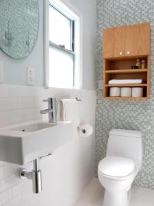 a bathroom with a sink and a toilet and a mirror at Garden View Guesthouse Fleurhof in Johannesburg