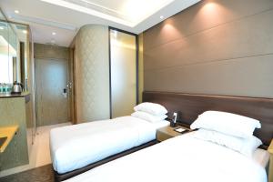 Voodi või voodid majutusasutuse Kew Green Hotel Mongkok toas