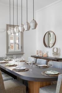 a dining room with a table with wine glasses at Villa Karma in Spetses