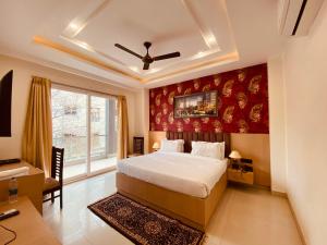 a bedroom with a bed and a large window at Hotel DSR Corporate Suite Sector 45 Gurgaon in Gurgaon