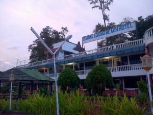 a building with a sign on top of it at Darma Agung Beach Hotel Parapat in Parapat