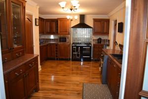 a kitchen with wooden floors and a black stove top oven at Spacious County Durham Home in Durham