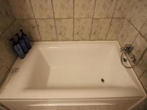 a white bath tub with a faucet in a bathroom at Hotel Travel in Incheon