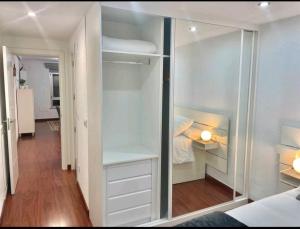 a bedroom with a walk in closet with a glass door at Piso nuevo Centro Doctor Casal in Oviedo