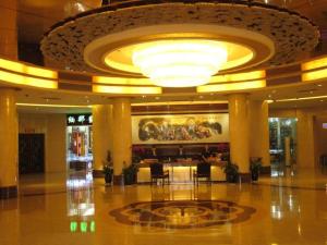 a large lobby with a large chandelier in a building at Kunming Zhong Huang Hotel in Kunming