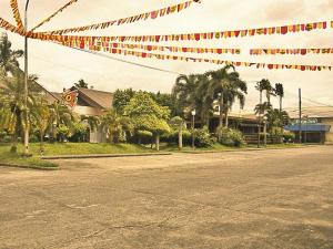 Mo2 Days Inn في Taculing Hacienda: شارع فارغ فيه مجموعه من الرايات الحمراء والبيضاء